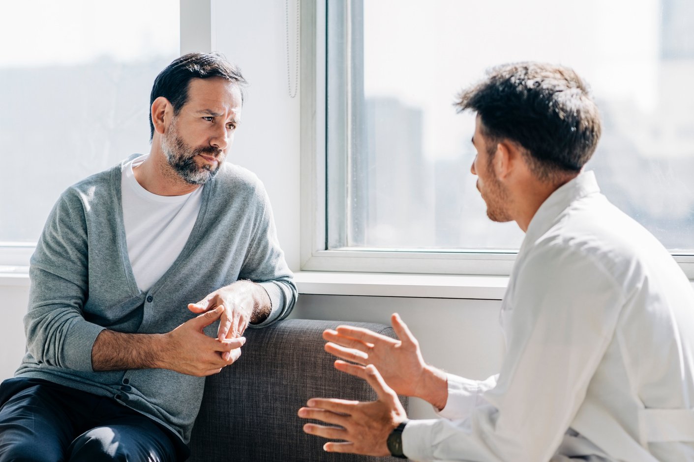 Doctor counseling mature patient in waiting room