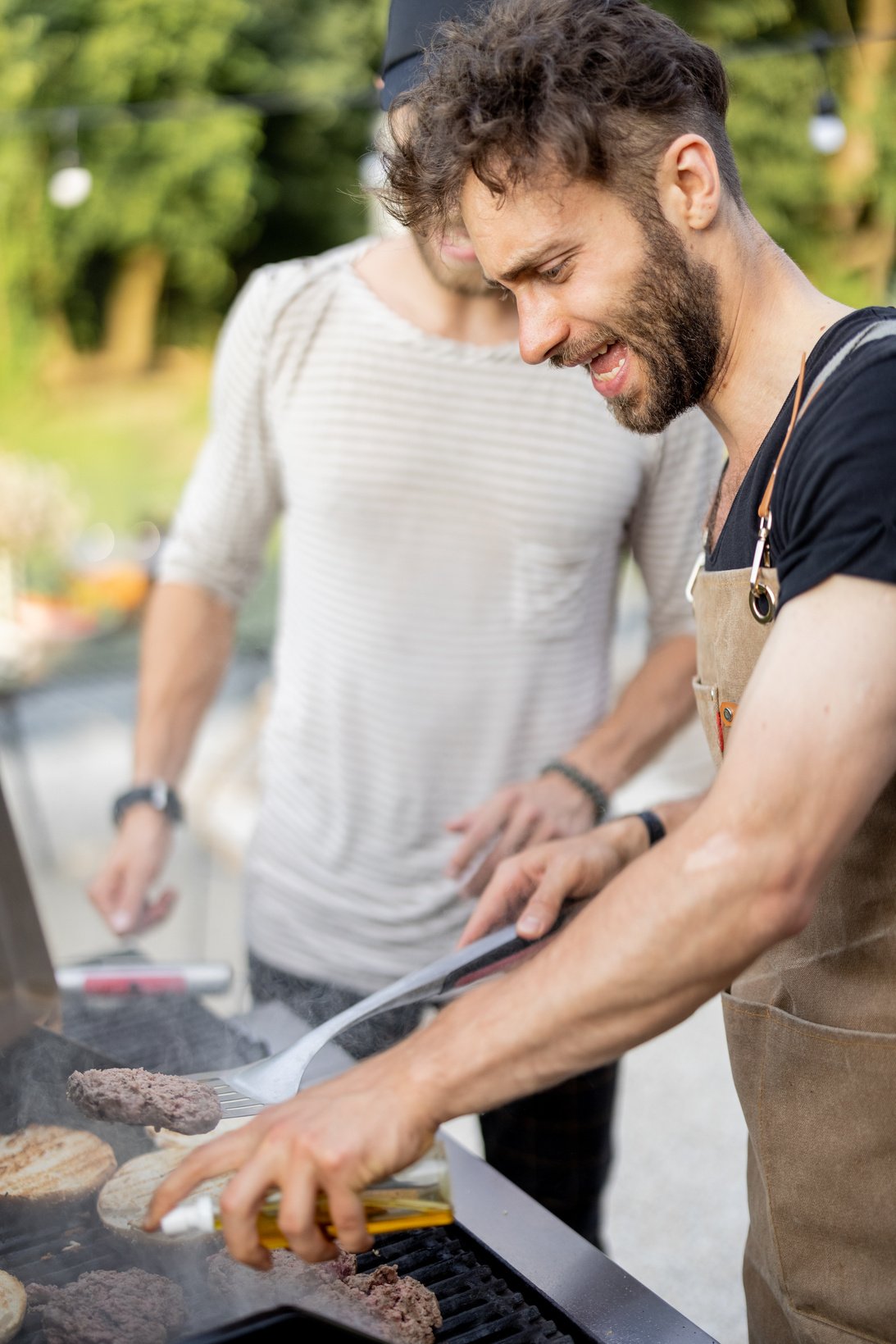 Two Guys Grilling at Backyard